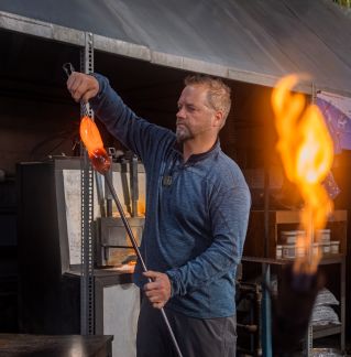 Man Using a Burner for Manufacturing Glass Items in a Workshop